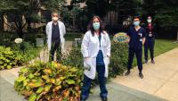 Child neurology residents standing the the hospital garden