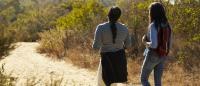 women walking on a trail
